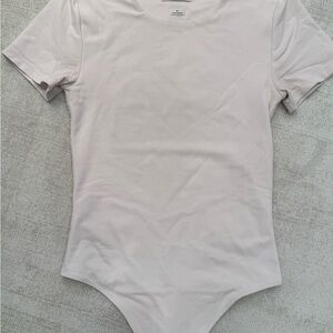 Babaton Short Sleeve One-Piece Bodysuit in eggshell off white color